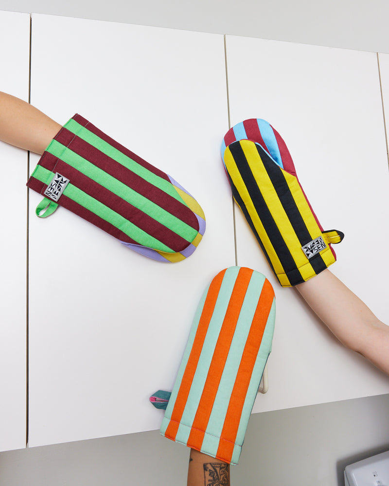 Available in Jalapeño, Mustard, and Ginger colorways. Padded oven mitt in contrasting stripe colorways. Features a