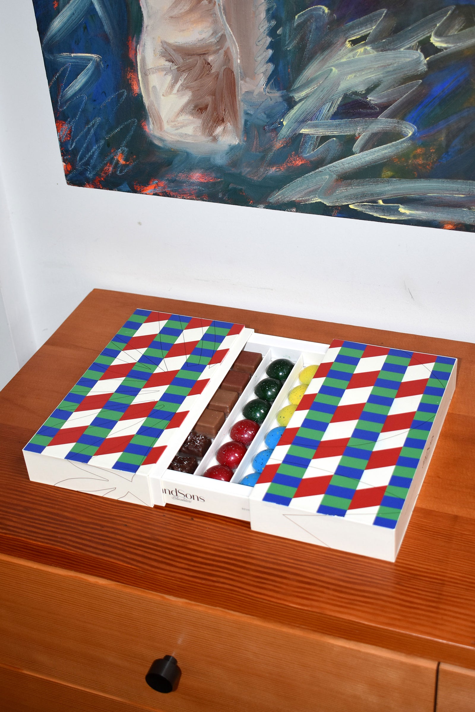 chocolates in box on wooden table