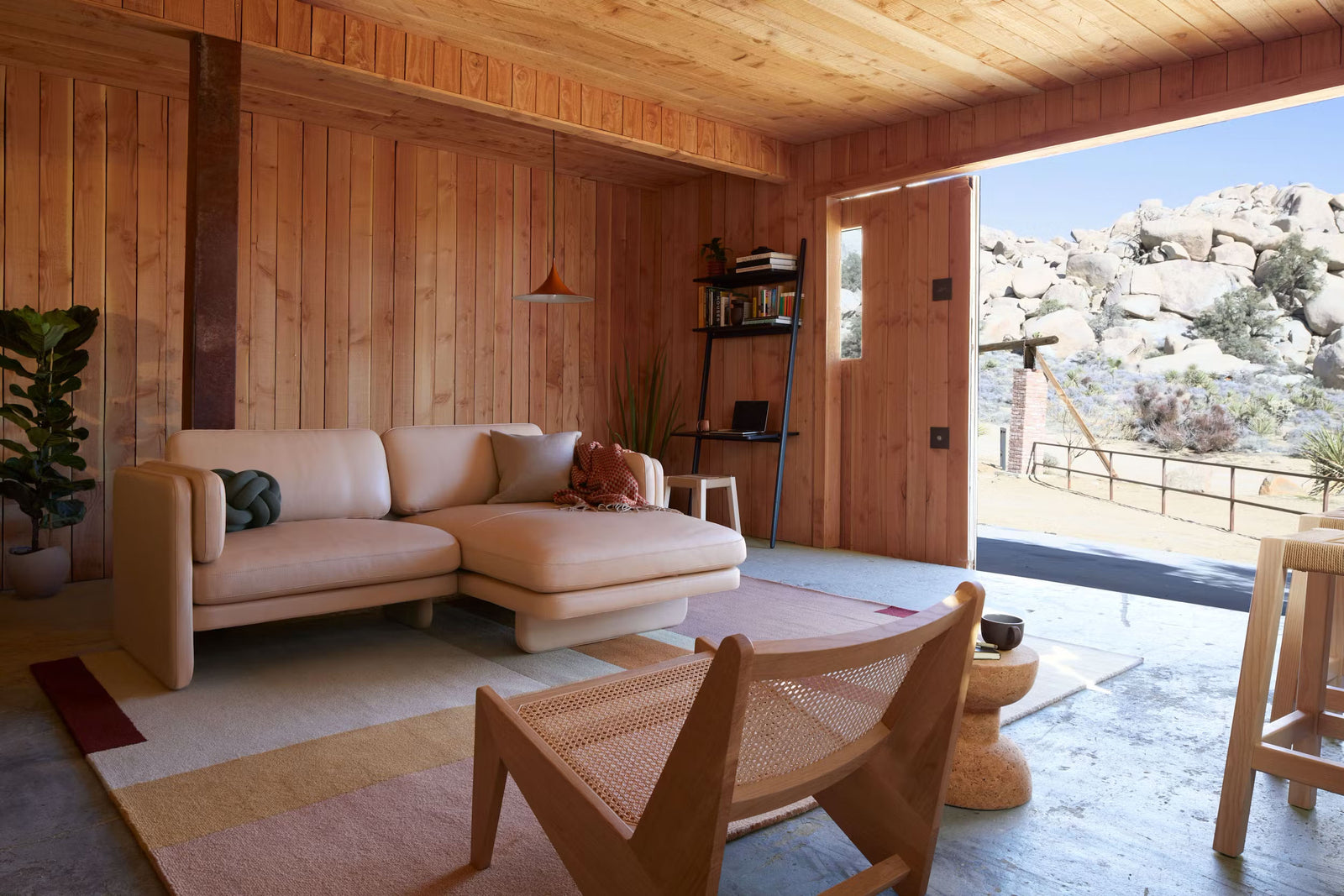 landscape rug in wooden interior with tan couch