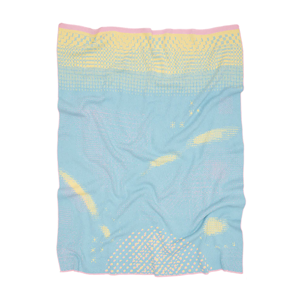 pastel blanket with yellow pixels across it and pink border