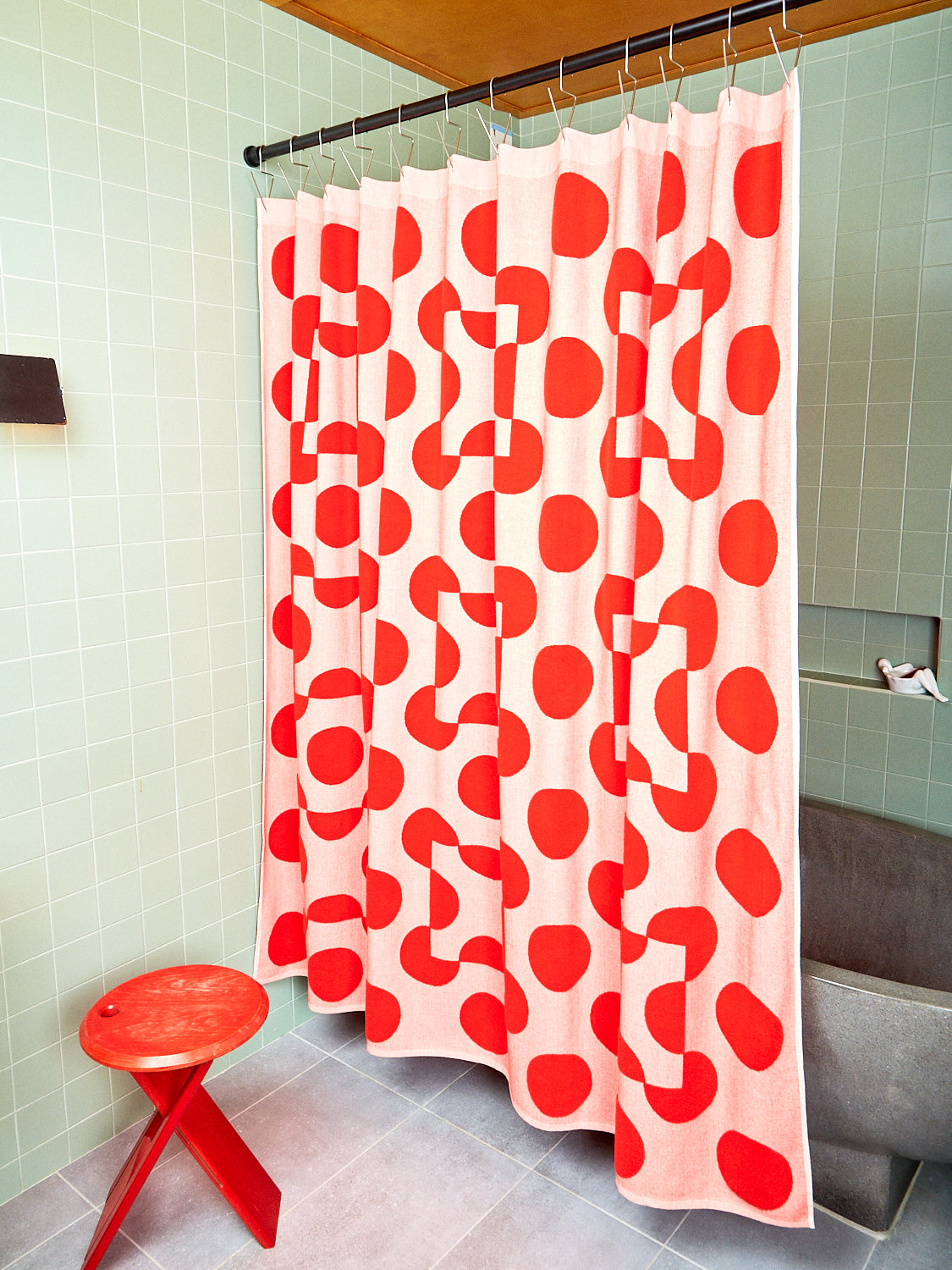 red and pink polka dot curtain with red stool