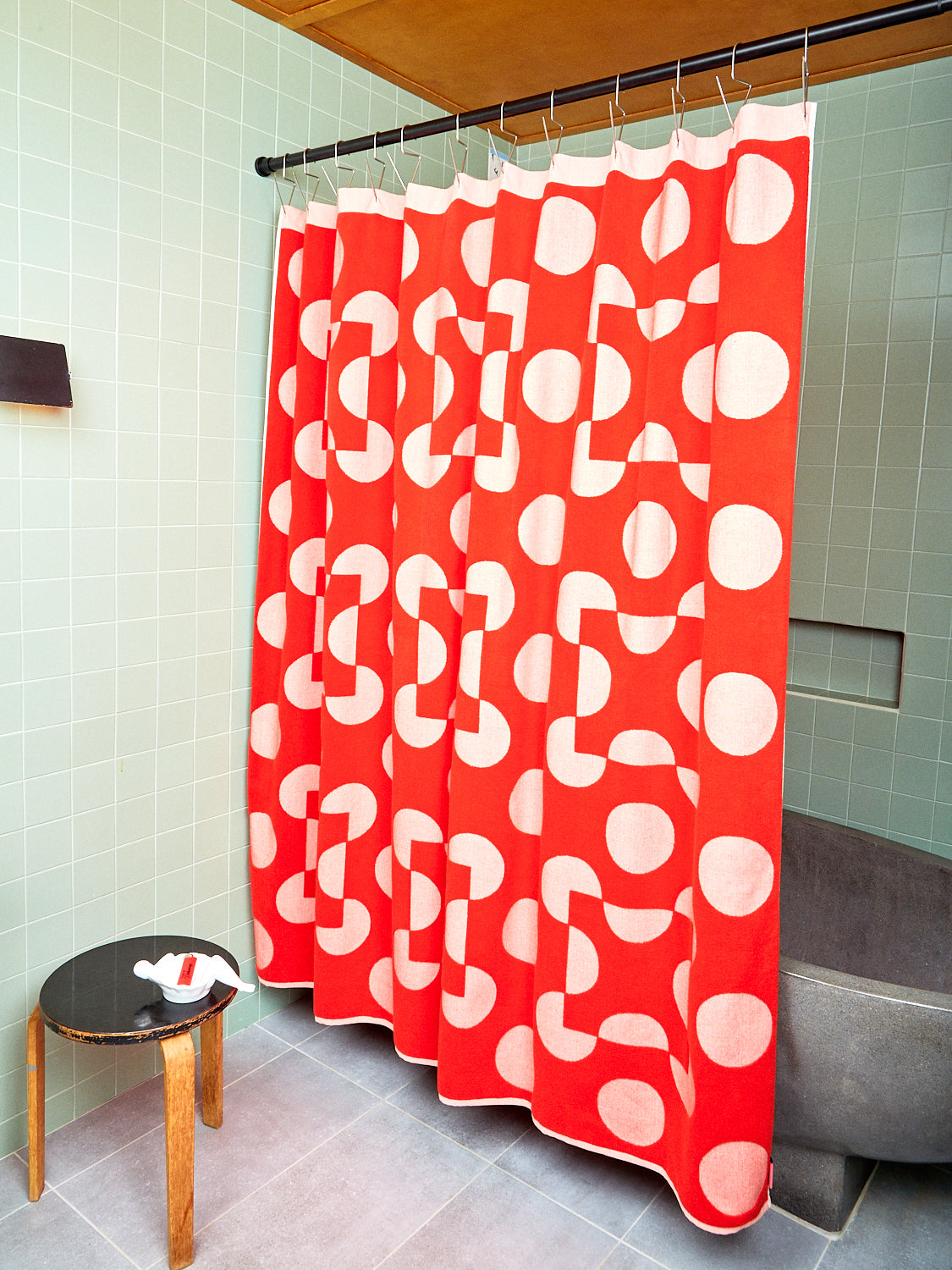 red and pink polka dot curtain with red stool in reverse side