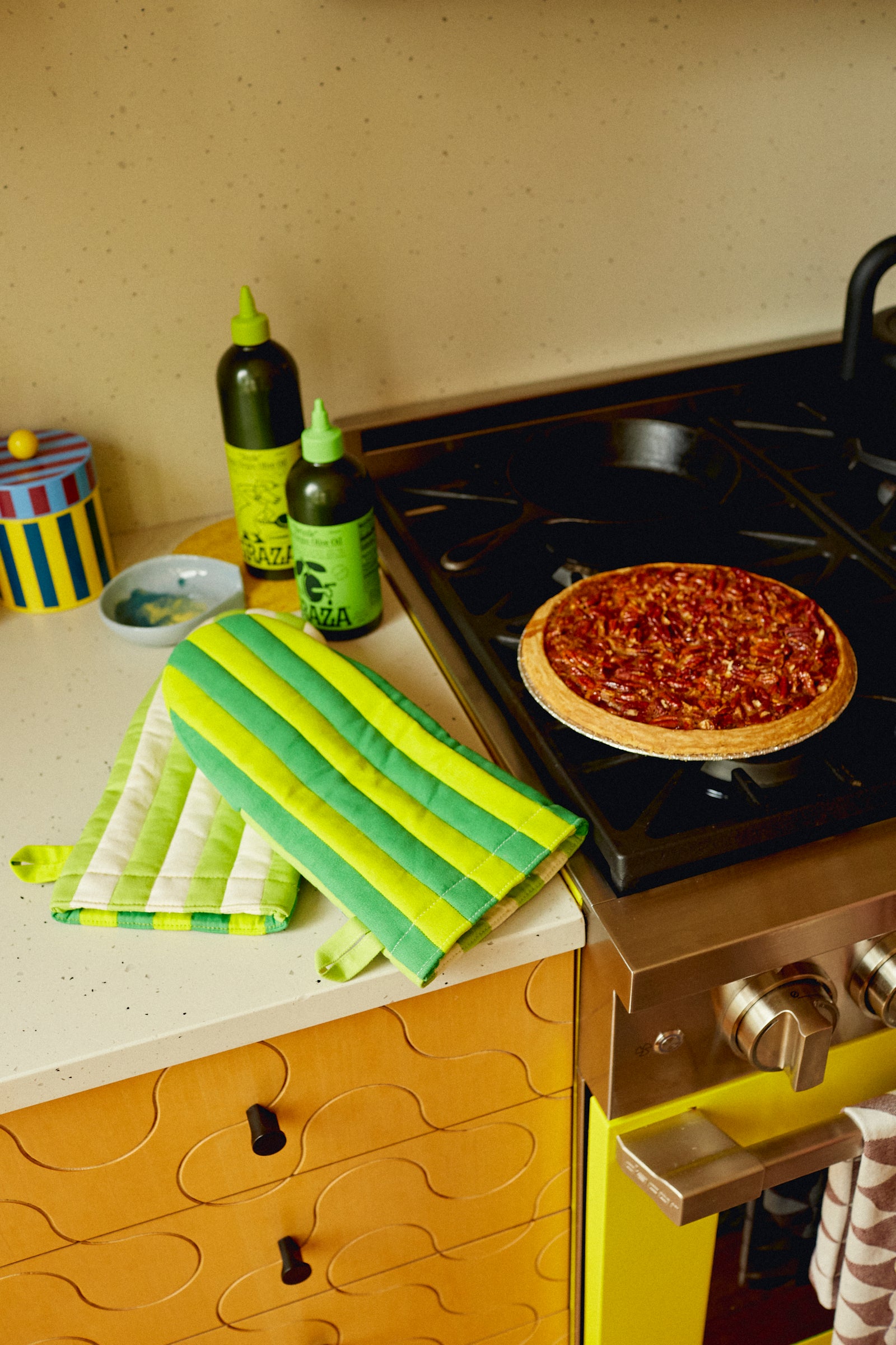 oven mitts and oil on counter