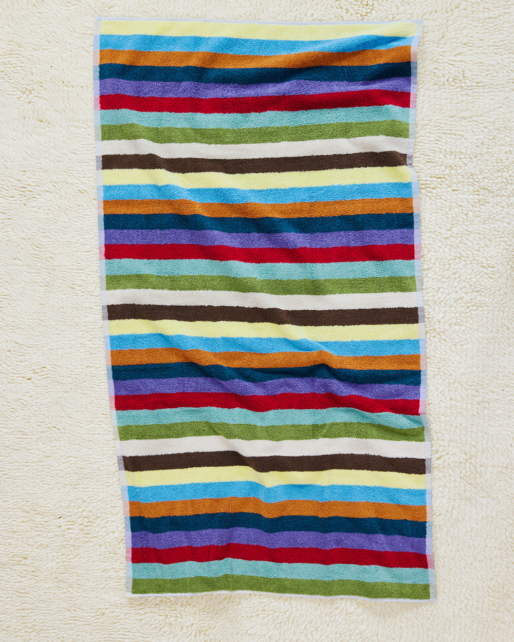 Hummingbird bath towel on carpet