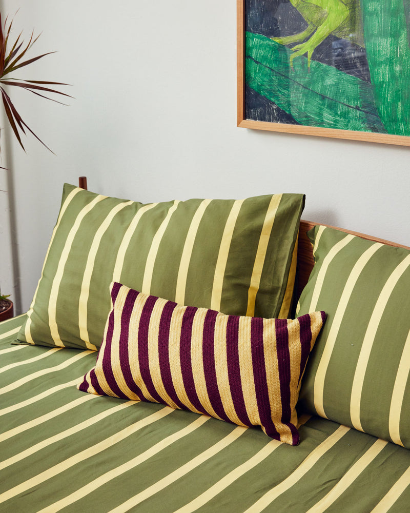 Sheeting in dark green and cream. 100% cotton sateen Flat sheet with tilt pillow bolster