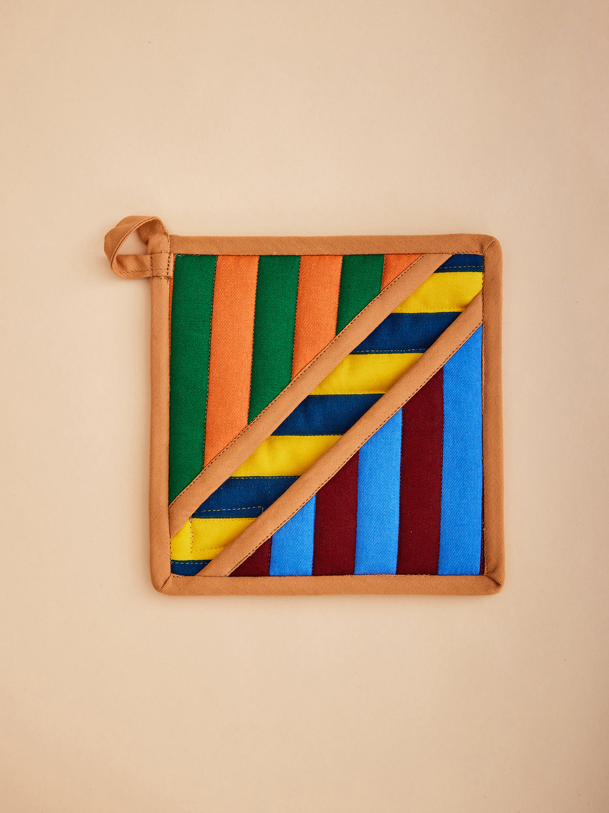 Dusen Dusen Stripe Pot Holder. Features a square pocket shape, top stitched brand label, and a side loop. 100% cotton quilted canvas base, with polyester fill.