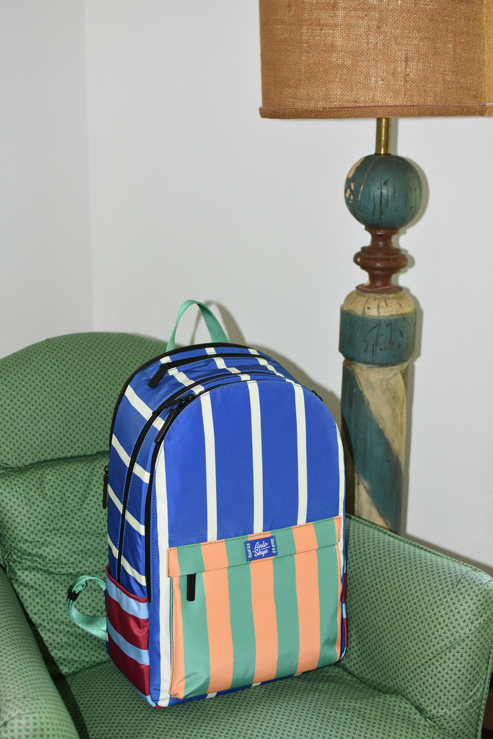 striped backpack on green chair