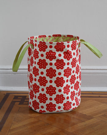 Raspberry Canvas hamper on wood floor