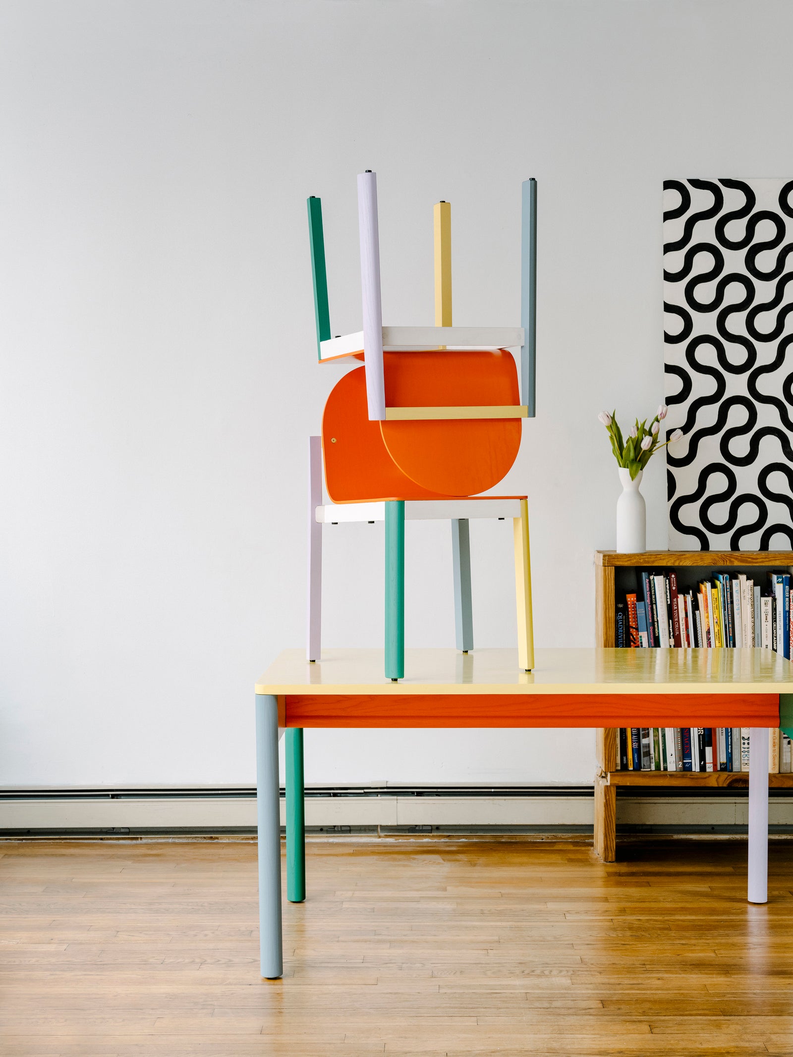 cleo chairs stacked on top of table