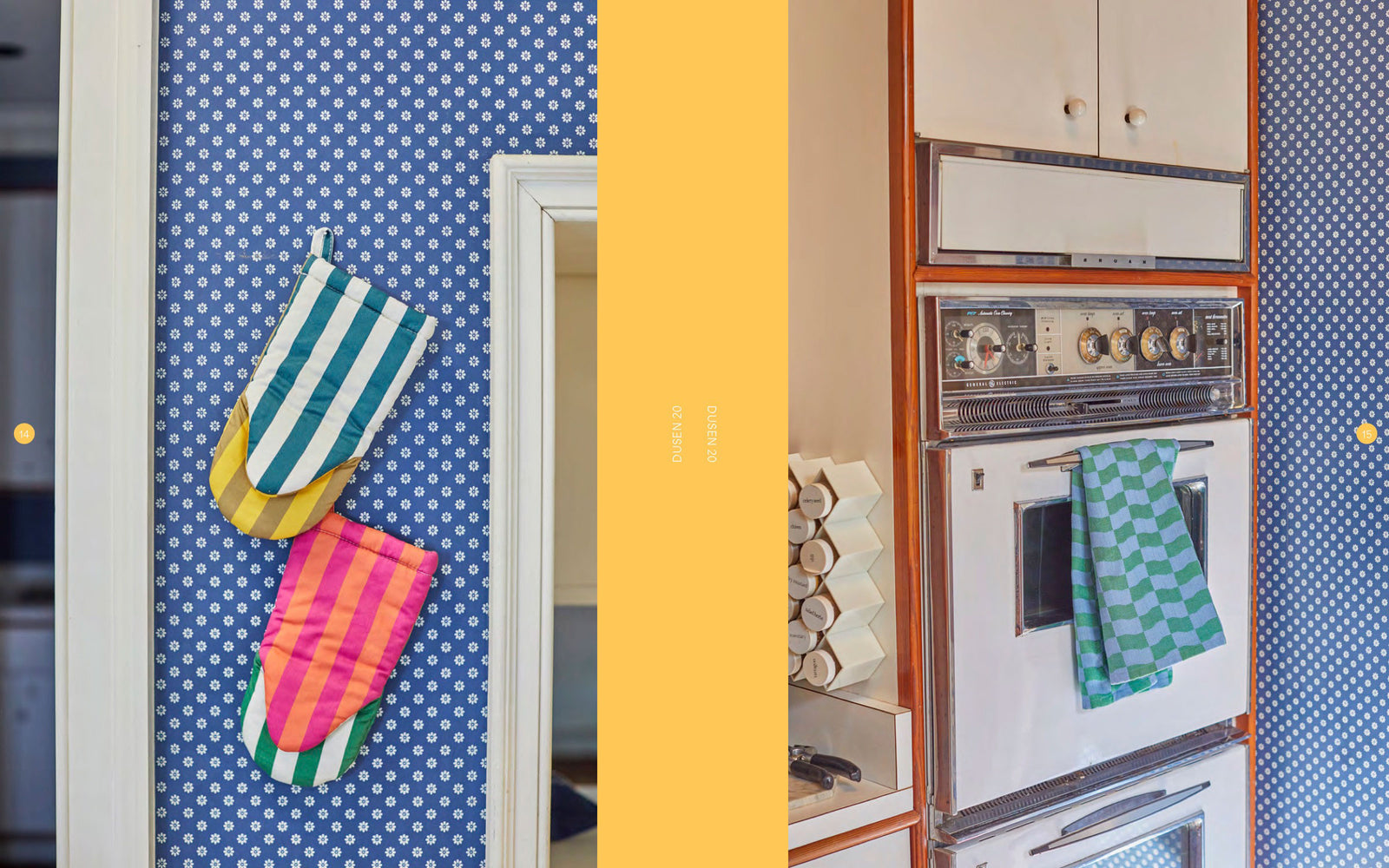 Blue wallpapered kitchen with dish towel on oven rack and oven mitts hanging on wall