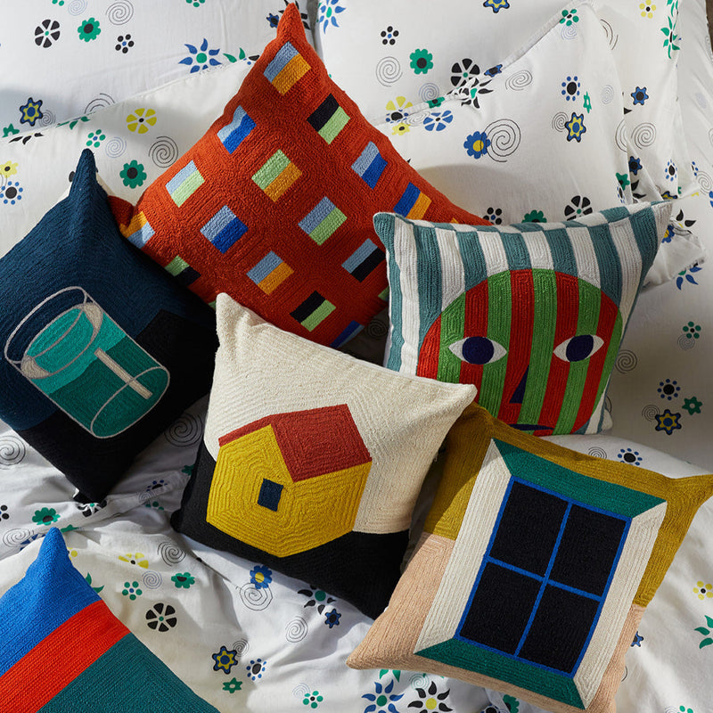 pillows from early collection of dusen dusen on bed including Face, Dash, Window, and Dot on Flower bedding