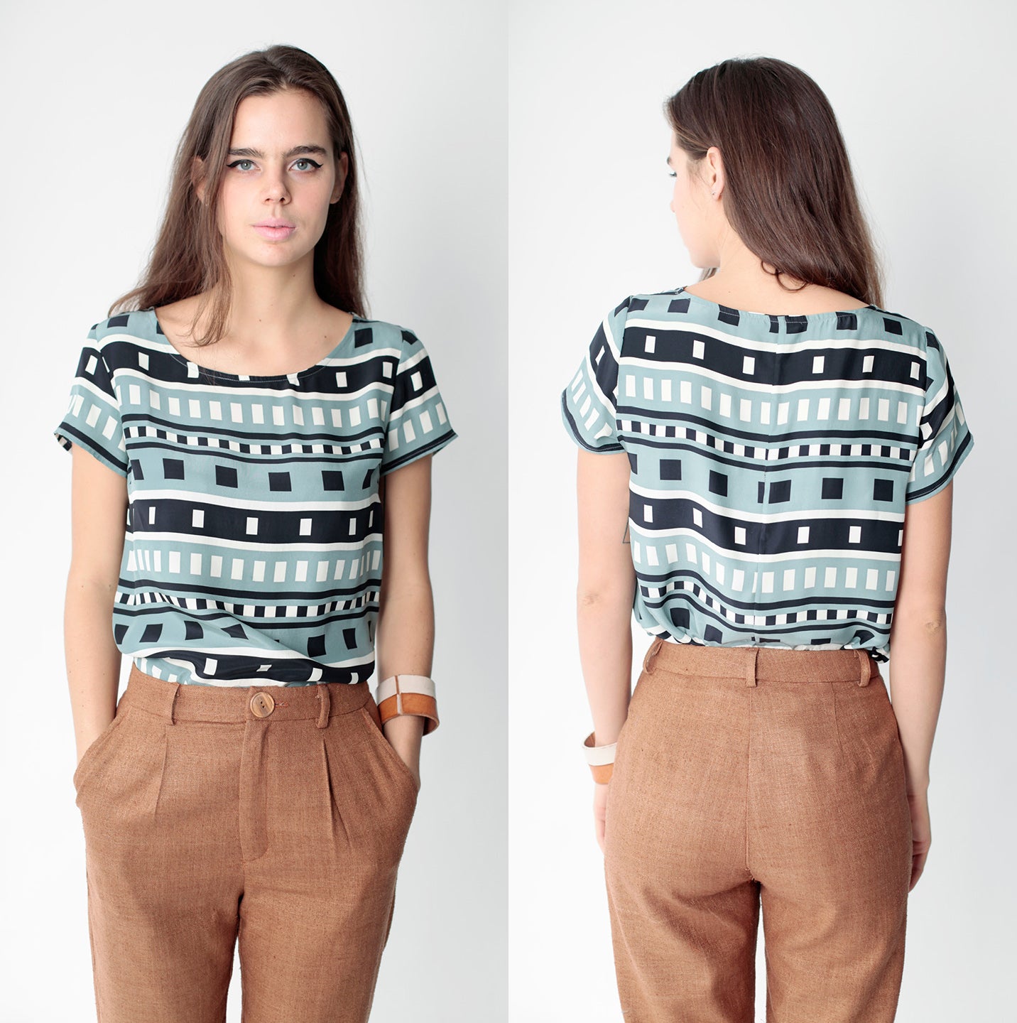 woman in tan pants and dusty blue black and white square pattern shirt
