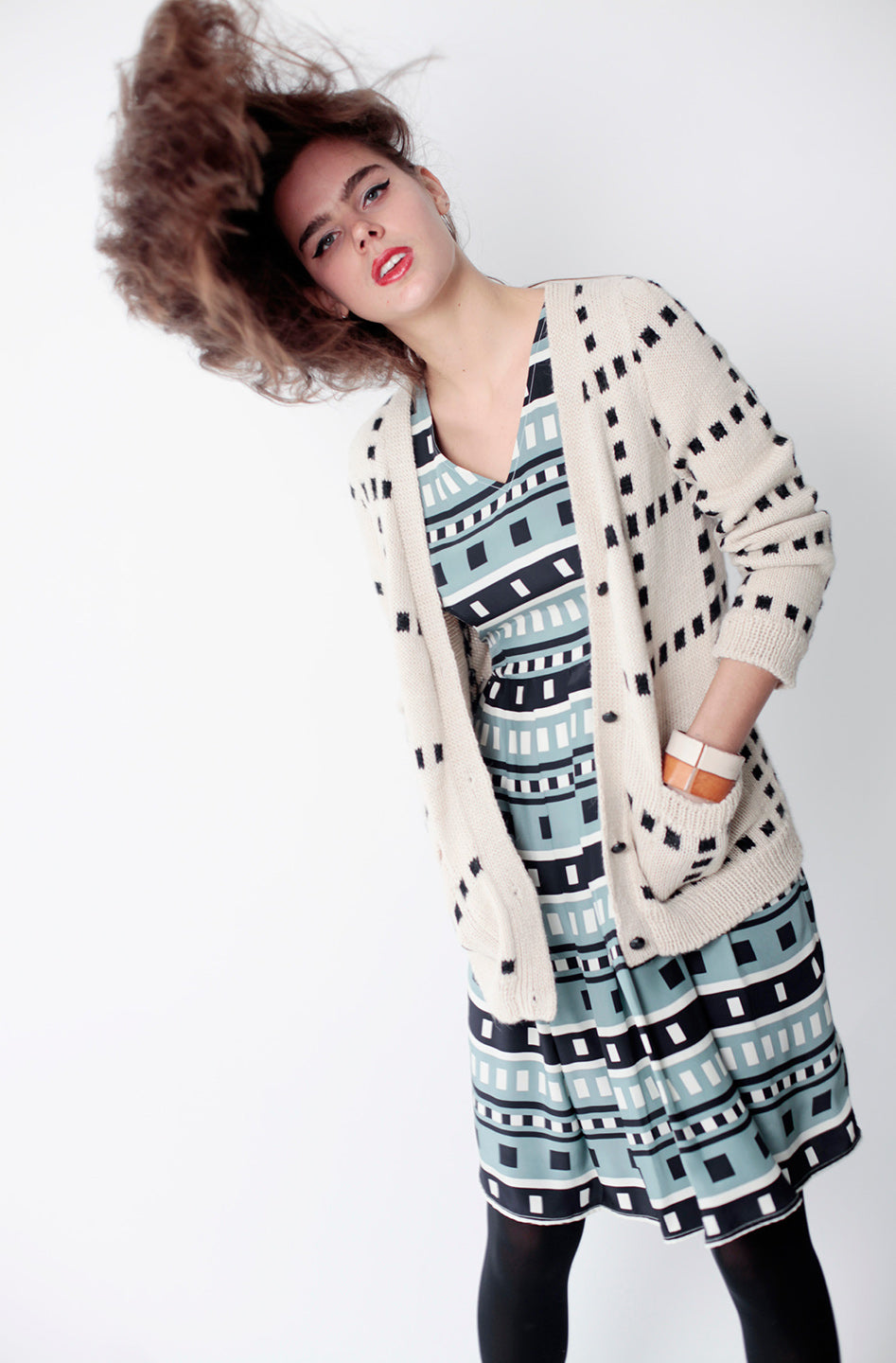 woman in dusty blue square pattern skater dress with grid cardigan