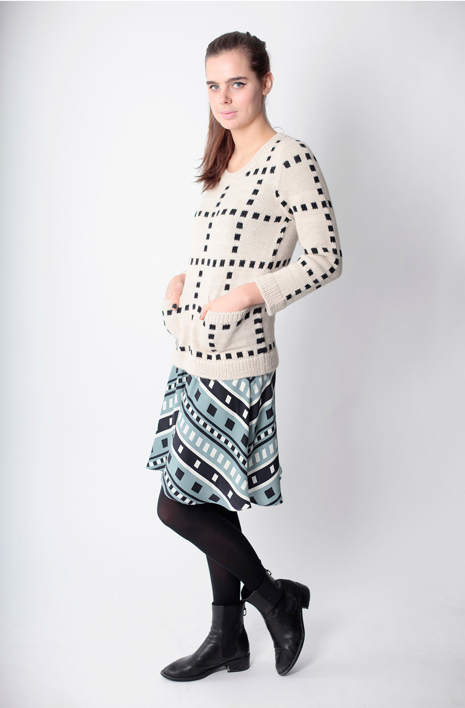 grid sweater with front pockets and square pattern skirt underneath
