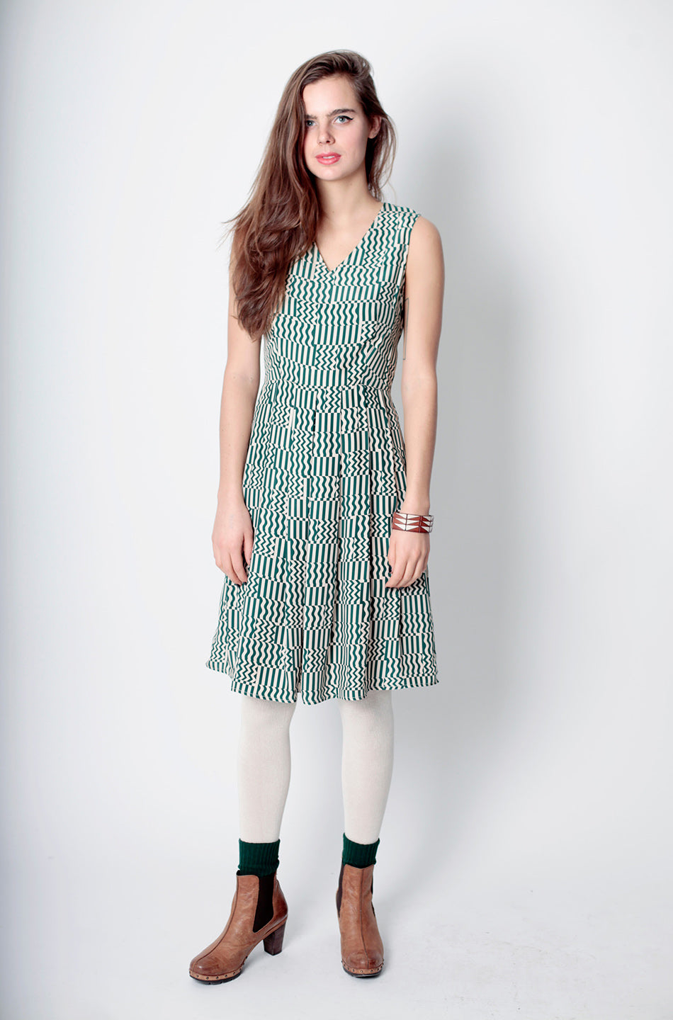 model in v neck pleated squiggle dress and white tights