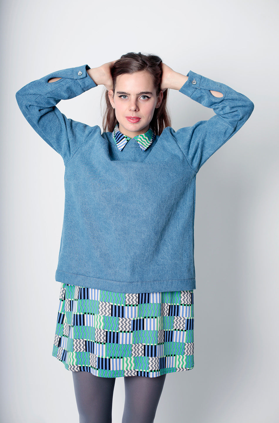 woman in denim blue top with squiggle block collared dress underneath
