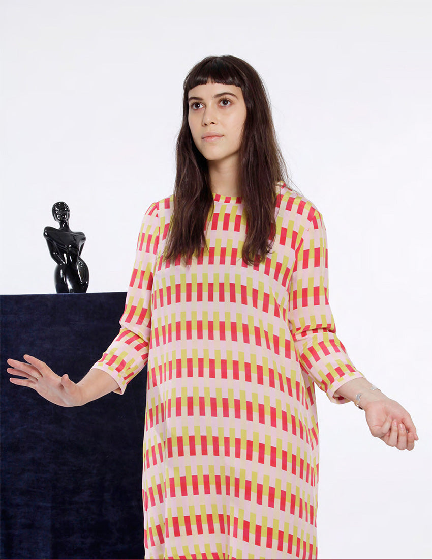 model with bangs in pink, red and yellow dress