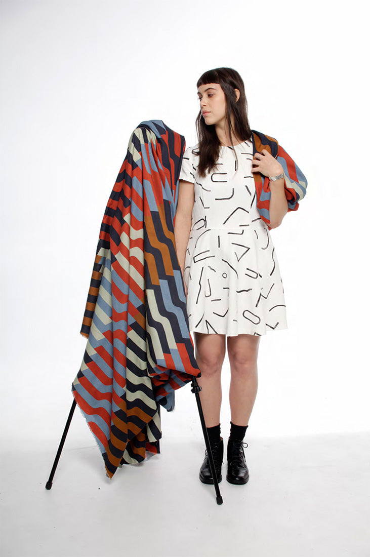 model in white line pattern dress with bunch of fabric