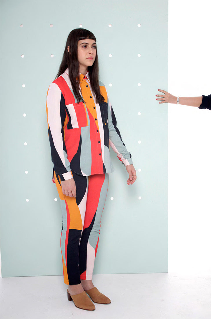 model in strong colorblock button up shirt and pants