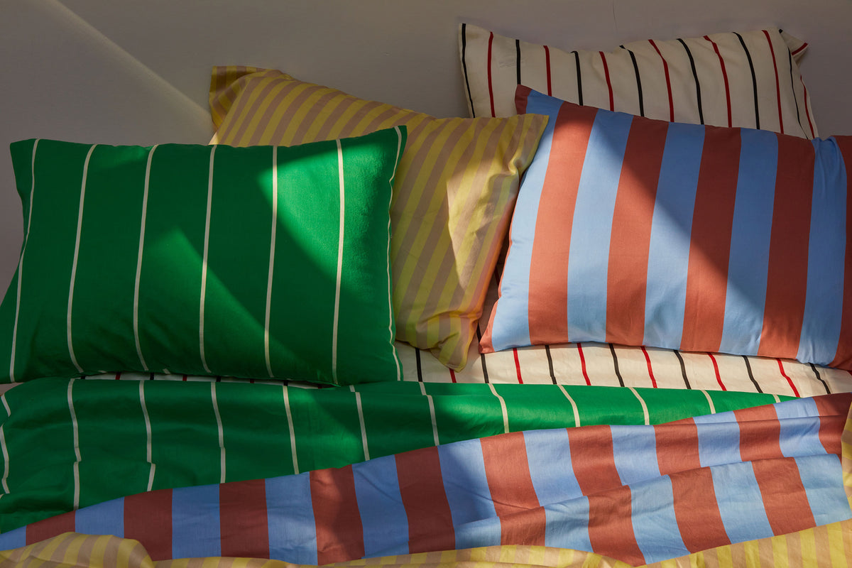 Dusen Dusen Canyon Stripe Sheets. Sheeting in soft blue and terra cotta stripes. 100% cotton sateen, 300 thread count. Machine wash cold and tumble dry. Made in Portugal. Our cotton sateen is smooth and cool to the touch and features a slightly lustrous finish.