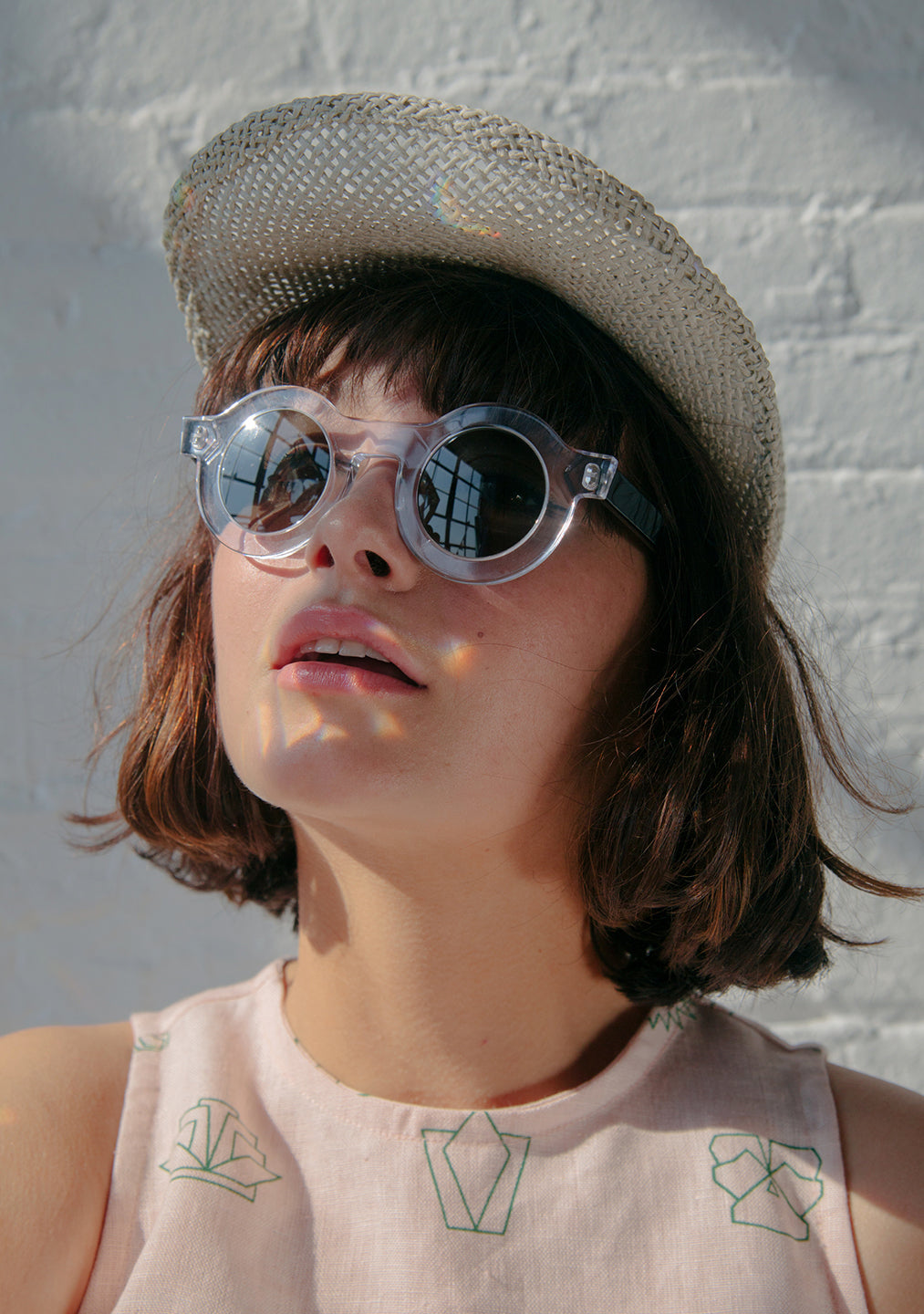 woman in round sunglasses and straw brim