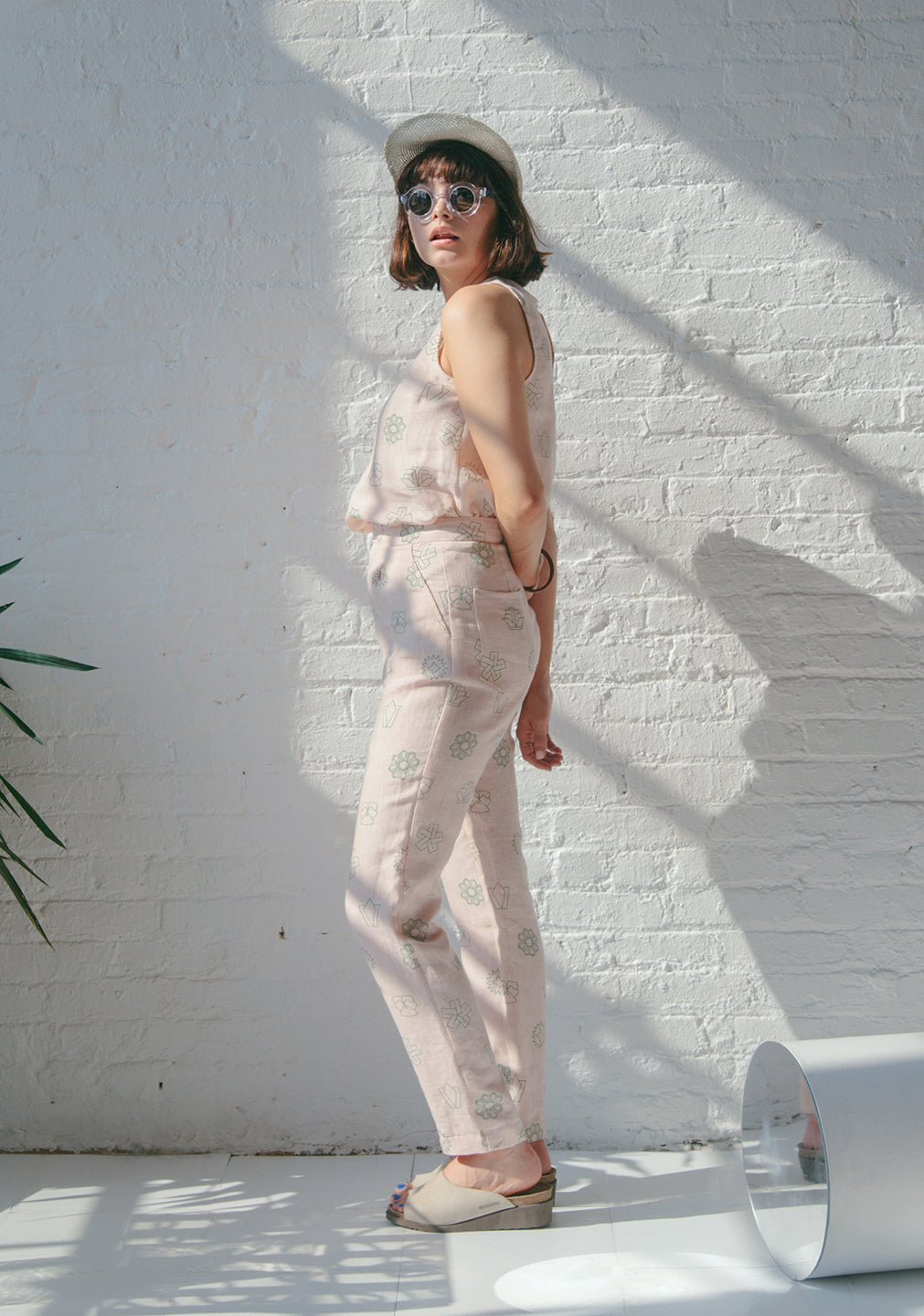 woman standing from side in light pink set