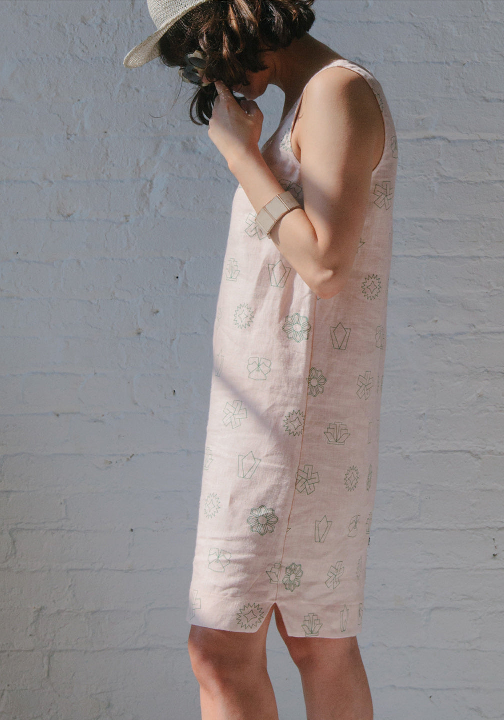 woman looking down in pink dress