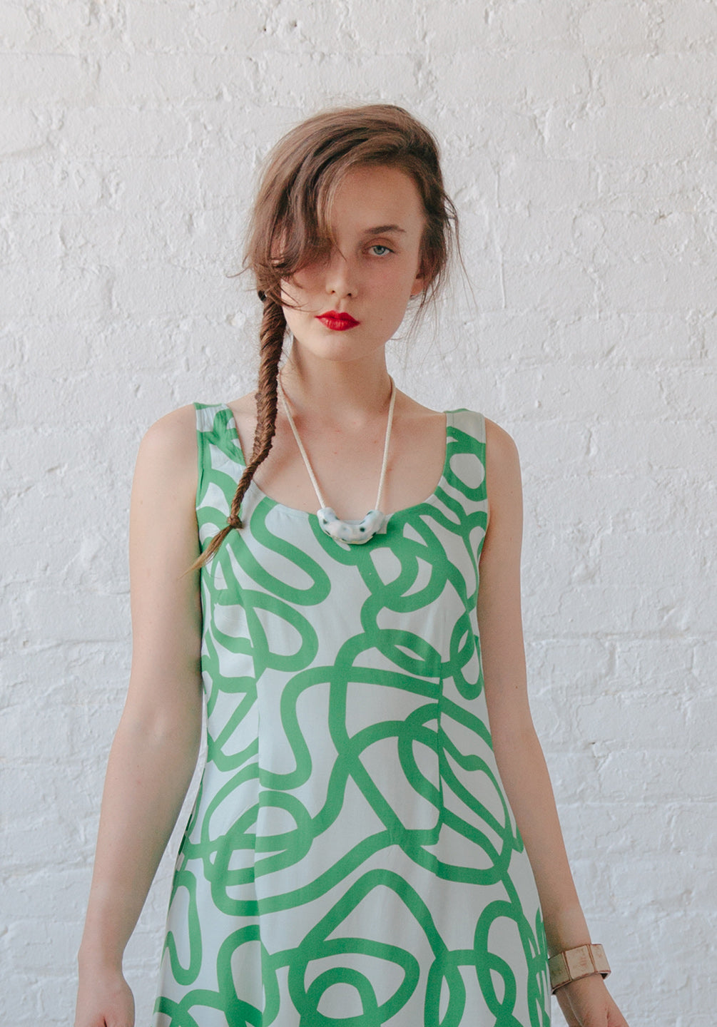 waist up of white dress with green squiggle on top