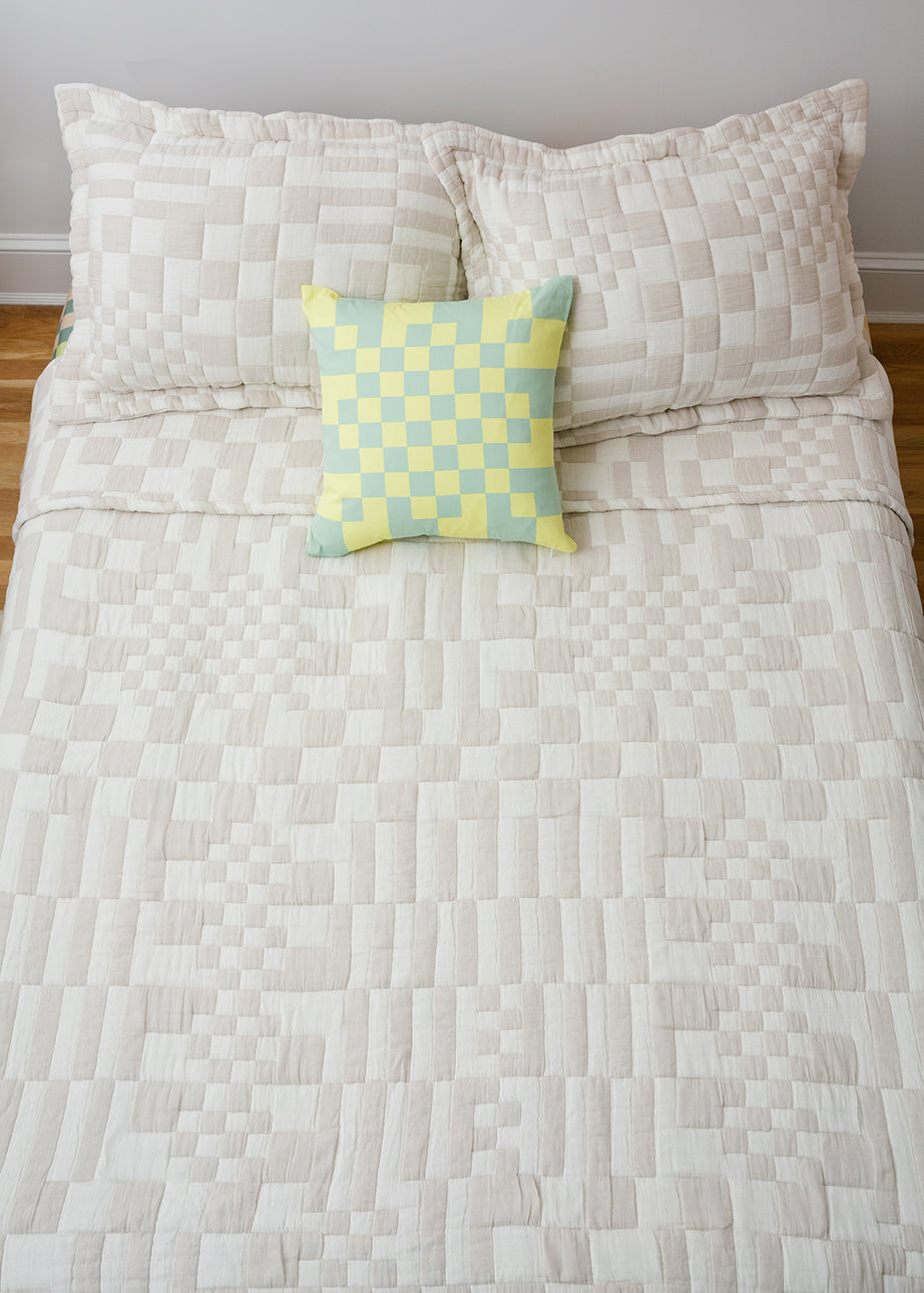 Check bedding with green check pillow on top
