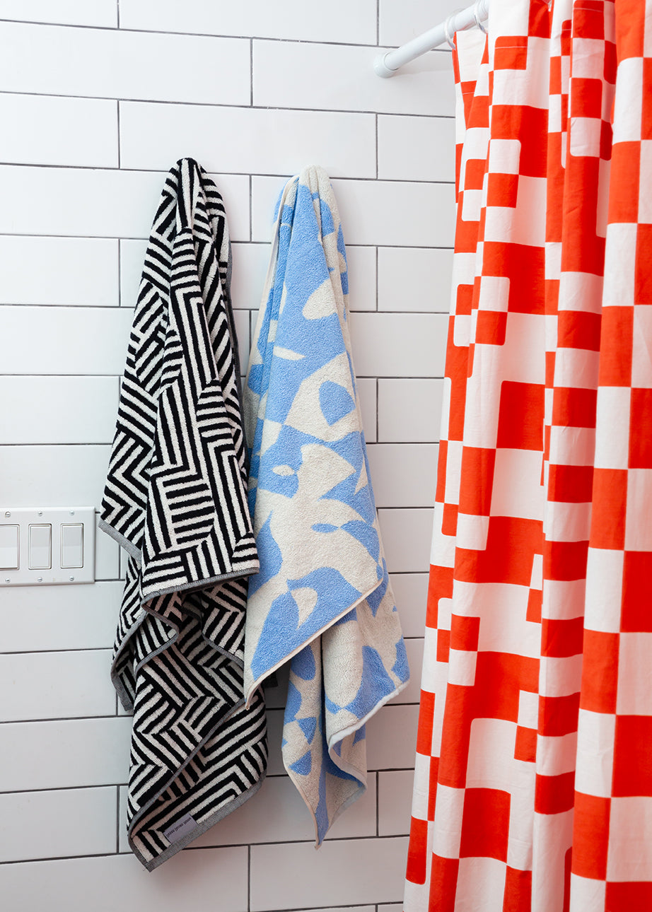colorful towels with red and white opaque shower curtain