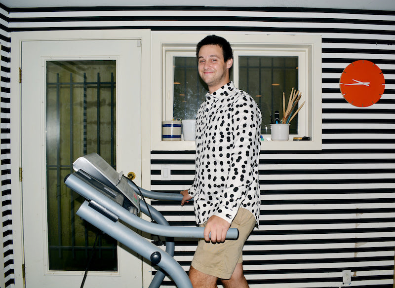 henry on exercise machine and black and white pattern button up