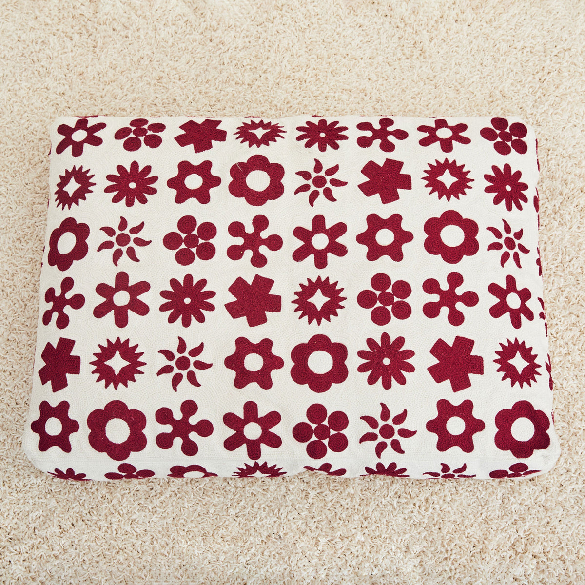 Dusen Dusen Wingdings Embroidered dog bed in maroon and cream Wingdings pattern. 100% cotton canvas base with acrylic chain embroidery, poly insert, and back zipper. 36"x 27"x 4". Doubles as floor pillow. Wash bed cover alone and inside-out in cold water. Line dry or lay flat to dry. Spot clean recommended. Made in China. Not eligible for international shipping;