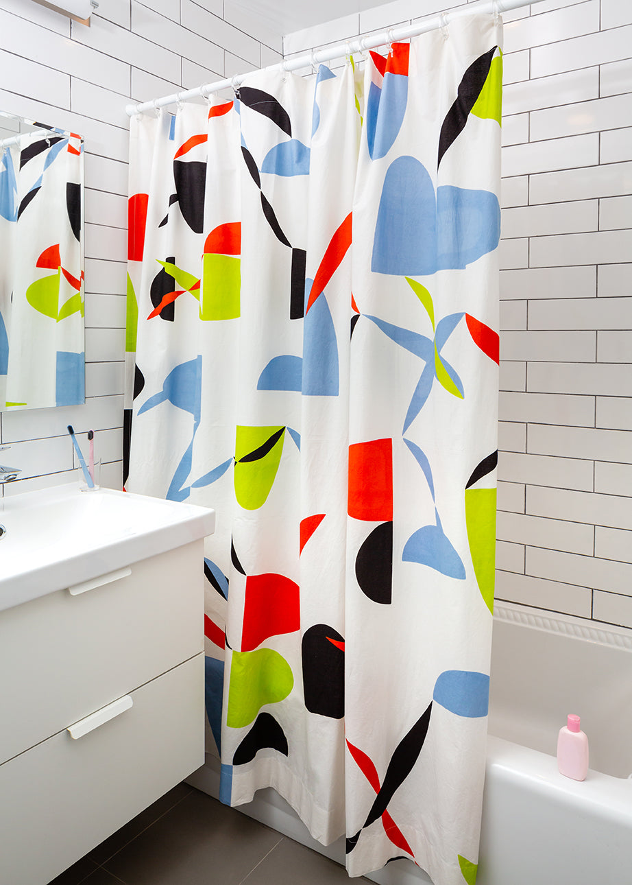 multicolored opaque showercurtain in white bathroom