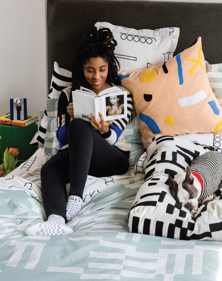 jessica williams in bed with pillows and dog bed and sleeping dog