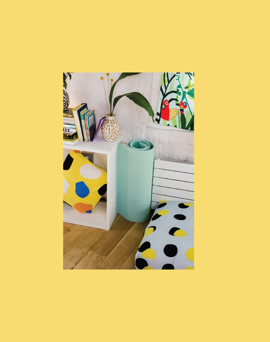green yoga mat between yellow pillow and dog bed