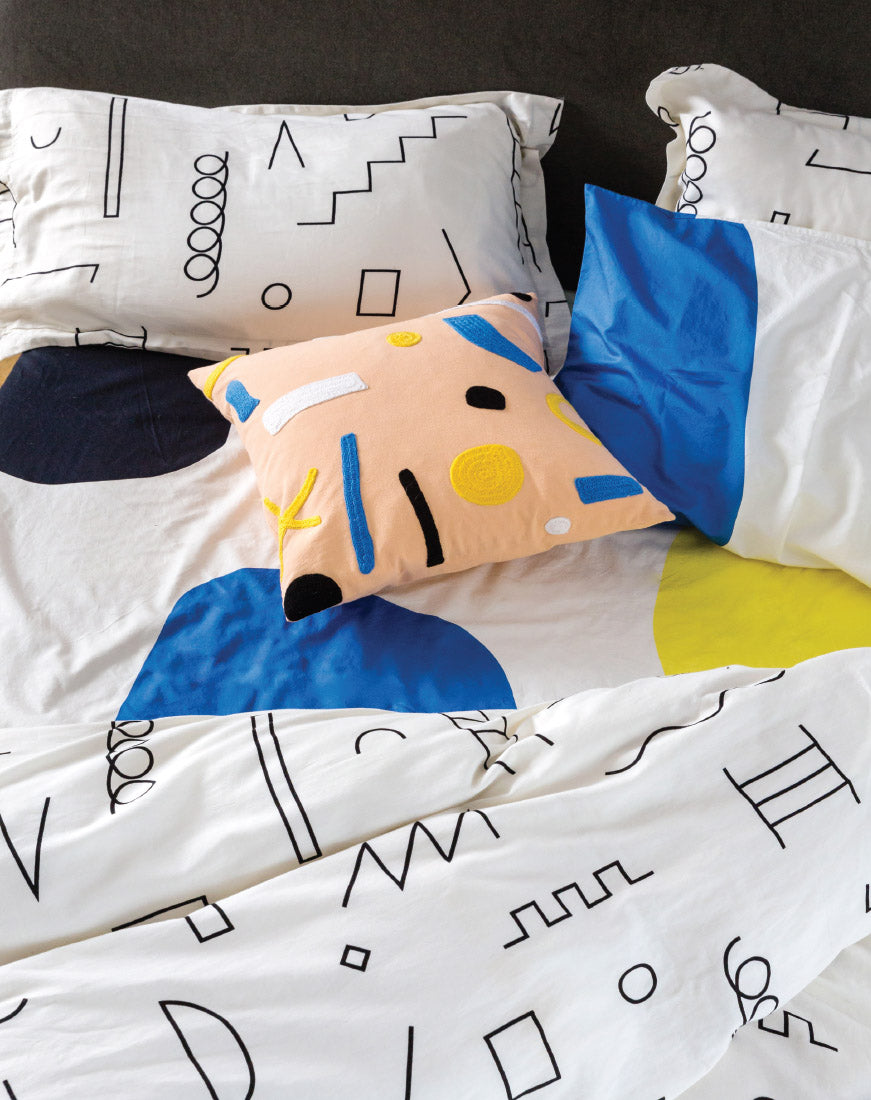 pastel pillows on doodle duvet and big color block sheets