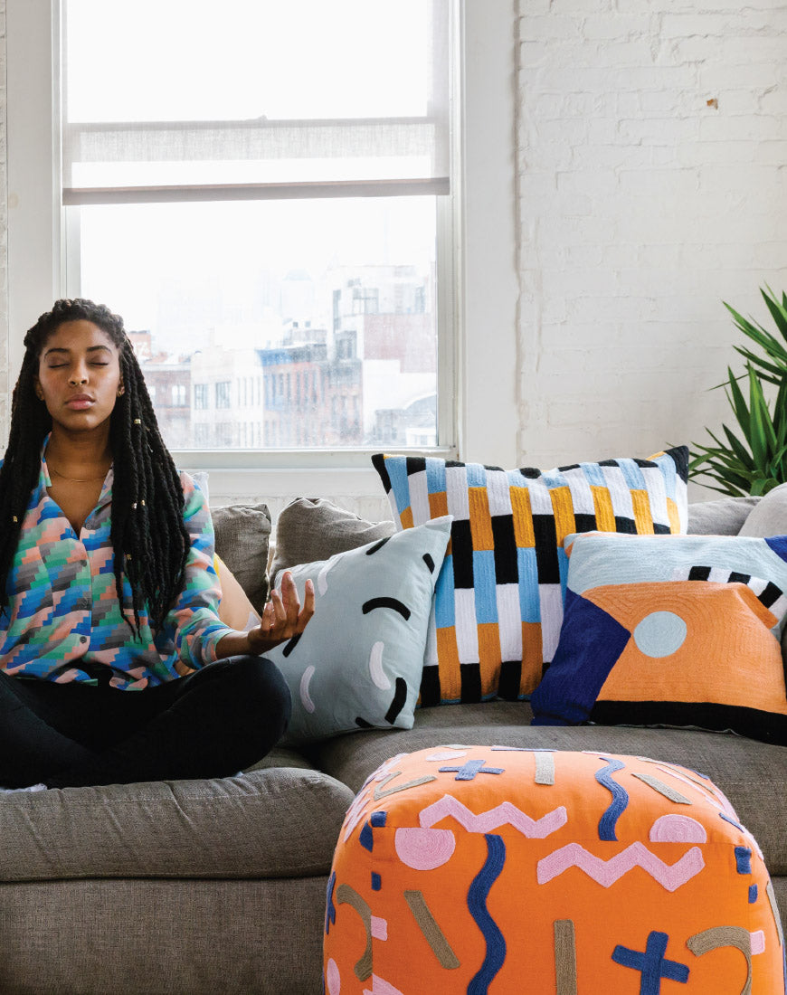 jessica on couh with orange pouf