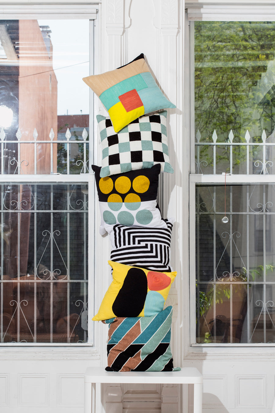 Pillow stack in front of windows