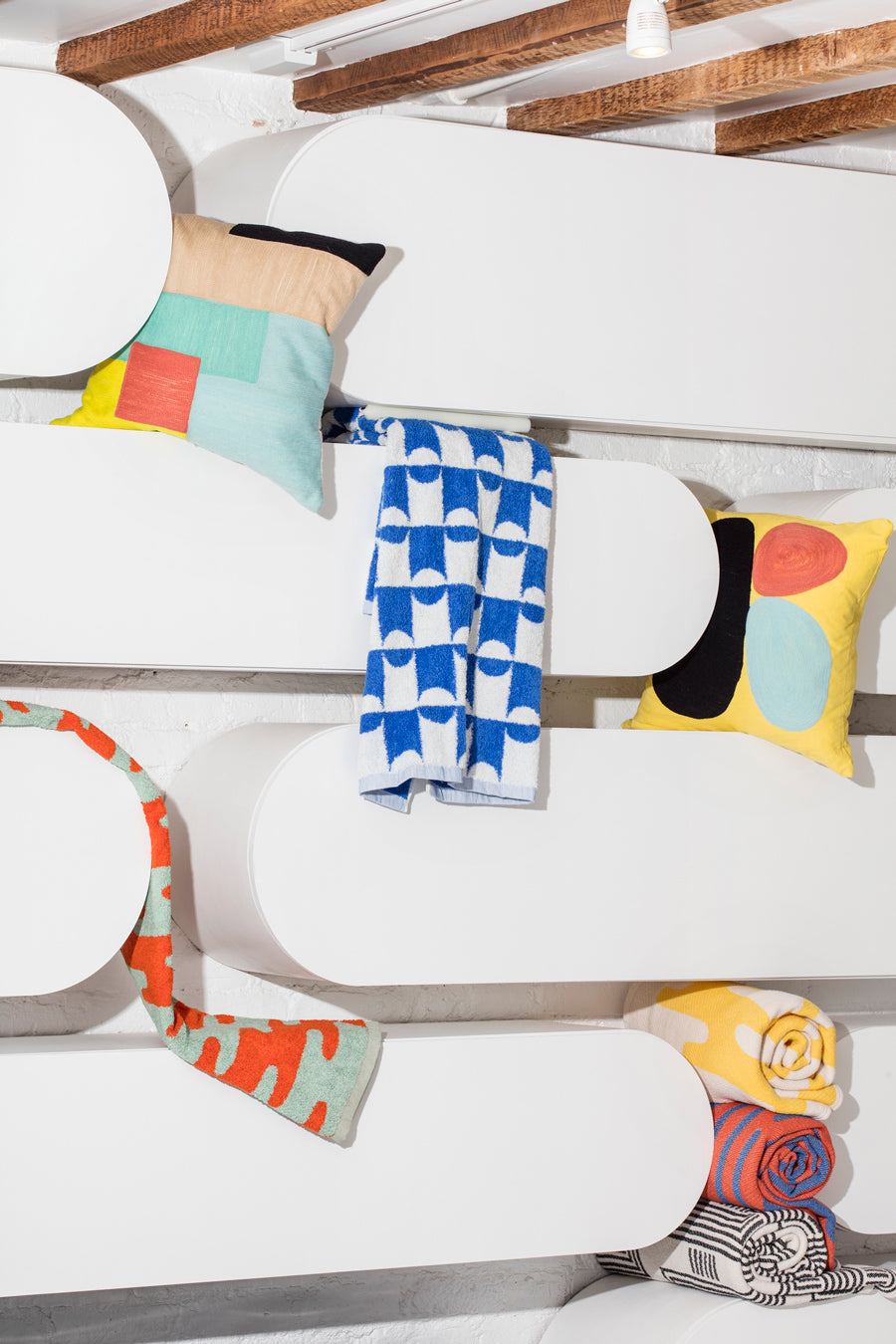 pattern towels and pillows on rounded shelves