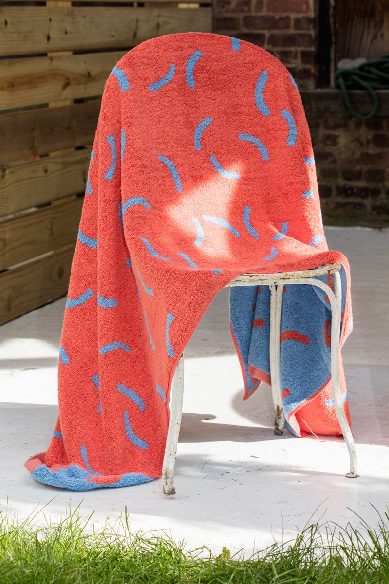 red and blue towel on chair