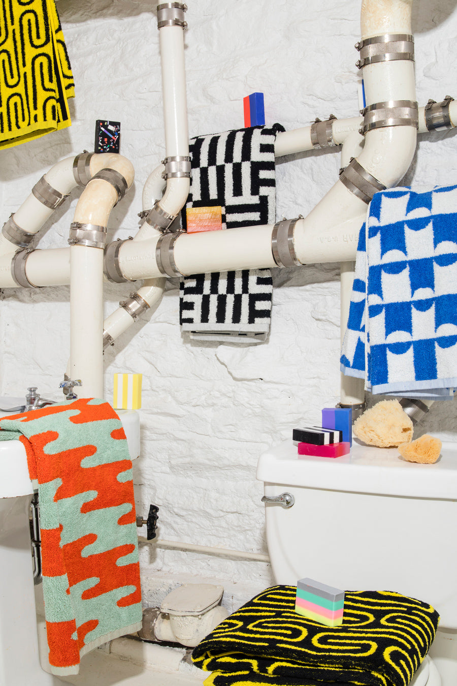 pattern towels on pipes with toilet