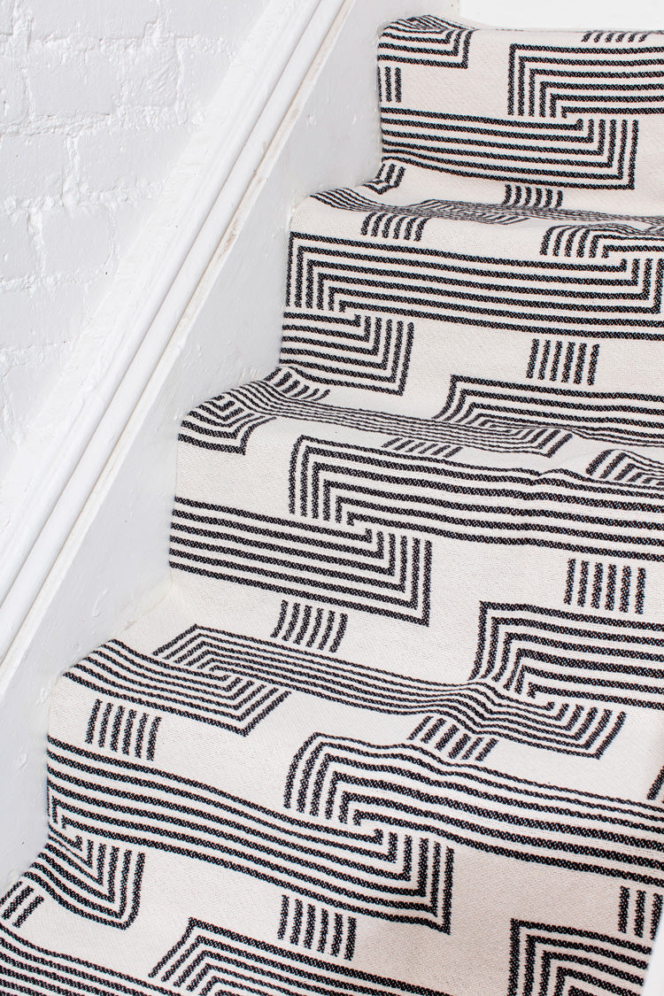 black and white rug on stairs