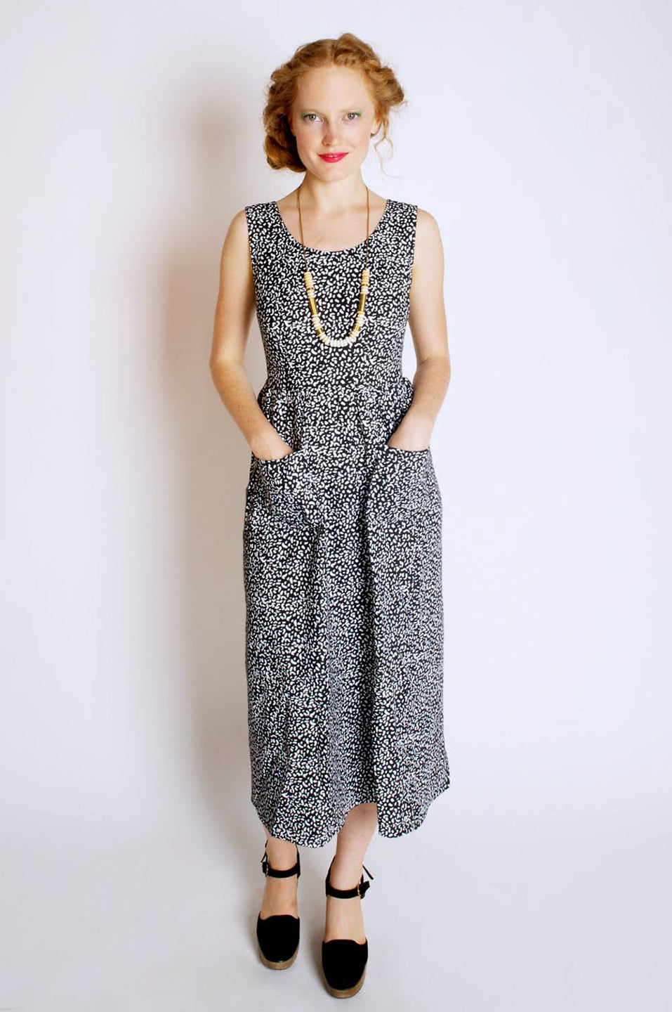 woman in black and white splatter long dress with front pockets