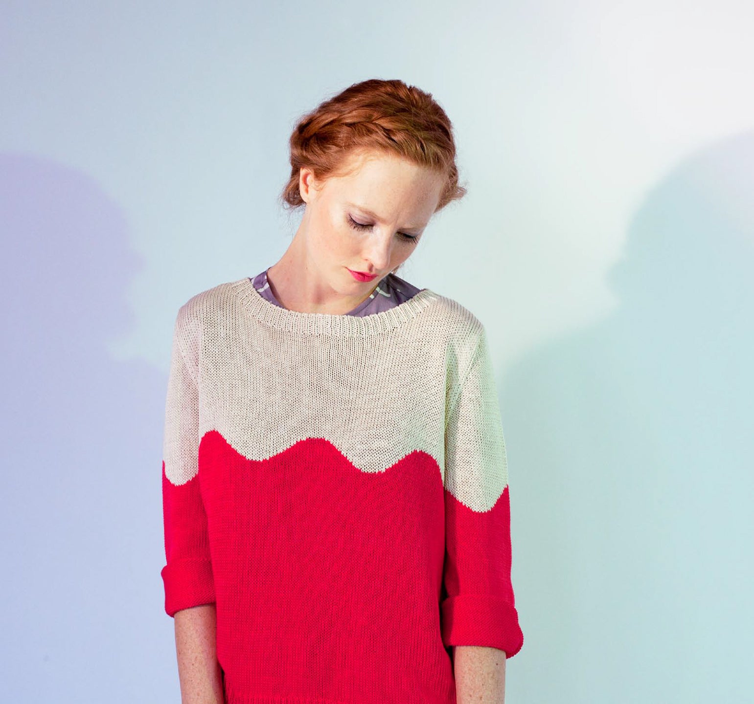 woman in red and white squiggle sweater