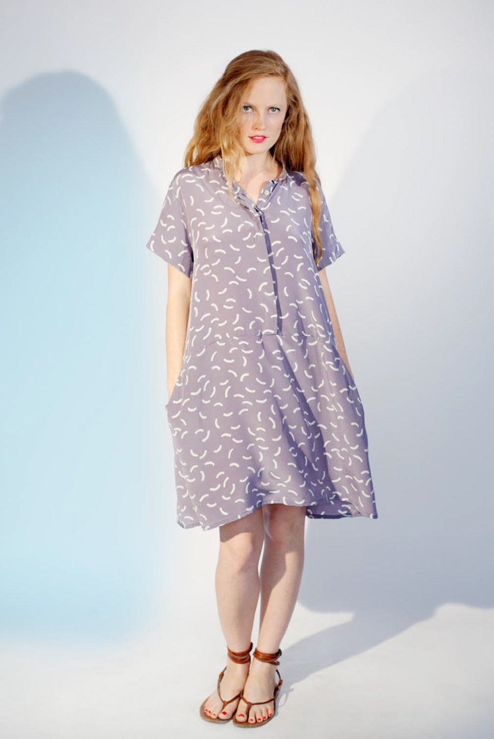 woman in purple dress shift button up flip flops