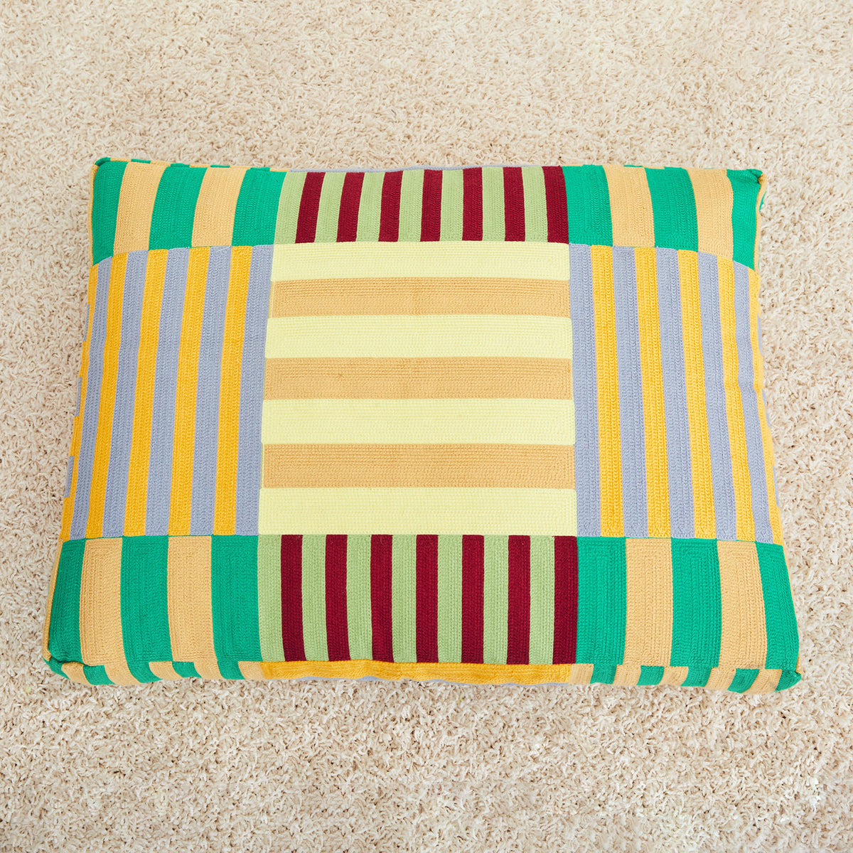 Dusen Dusen Stripe Embroidered dog bed in a multi-color, alternating Stripe pattern. 100% cotton canvas base with acrylic chain embroidery, poly insert, and back zipper. 36"x 27"x 4". Doubles as floor pillow. Wash bed cover alone and inside-out in cold water. Line dry or lay flat to dry. Spot clean recommended. Made in China;