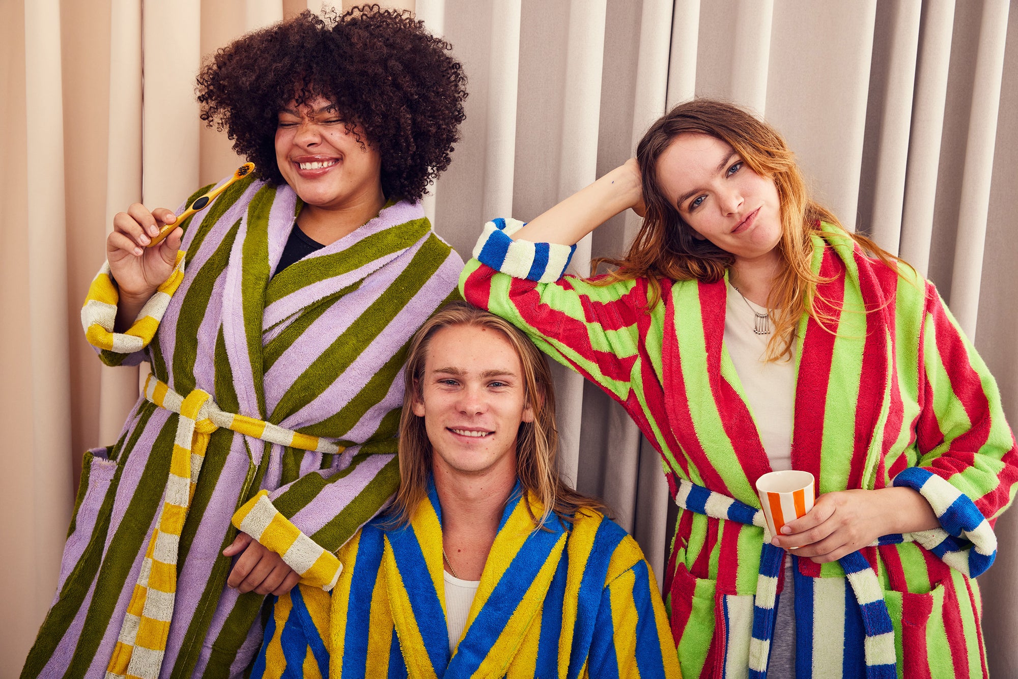 Three models in Sea Stripe bathrobe, Reef Stripe bathrobe, and Garden Stripe bathrobe