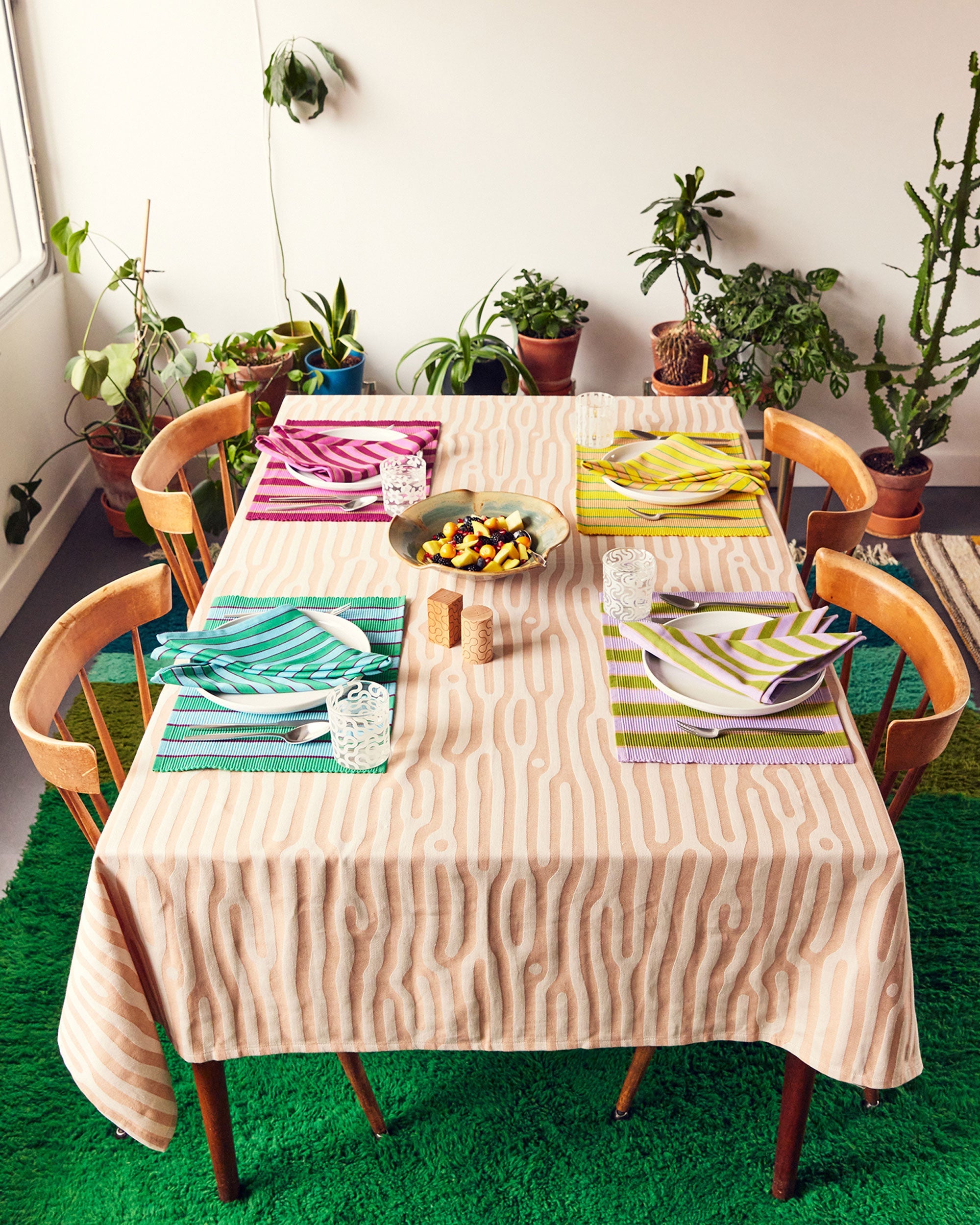 Dusen Dusen pink, yellow, blue, purple stripe placemats and napkins on tree pattern tablecloth