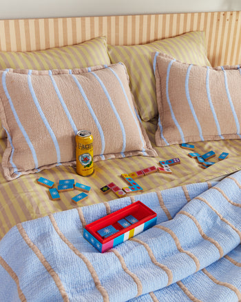 ["Dusen Dusen Wave Coverlet Set. Coverlet Set with Beige background and blue squiggles . Woven matelassé coverlet with an inner layer of insulation for a quilted effect. ", " This blanket is a real dream weaver!"]