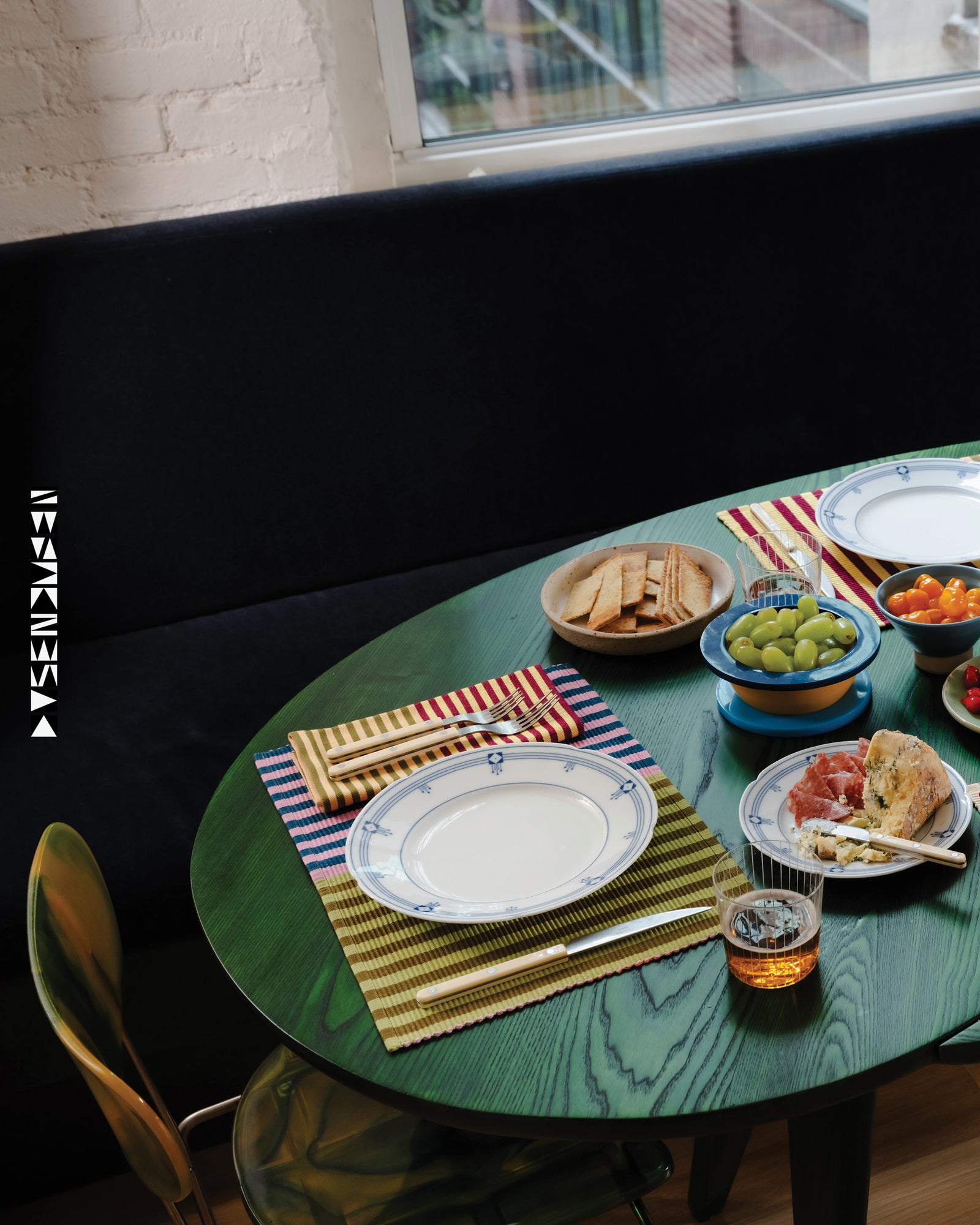 Dining table set with plates, cutlery, and food in a casual setting.